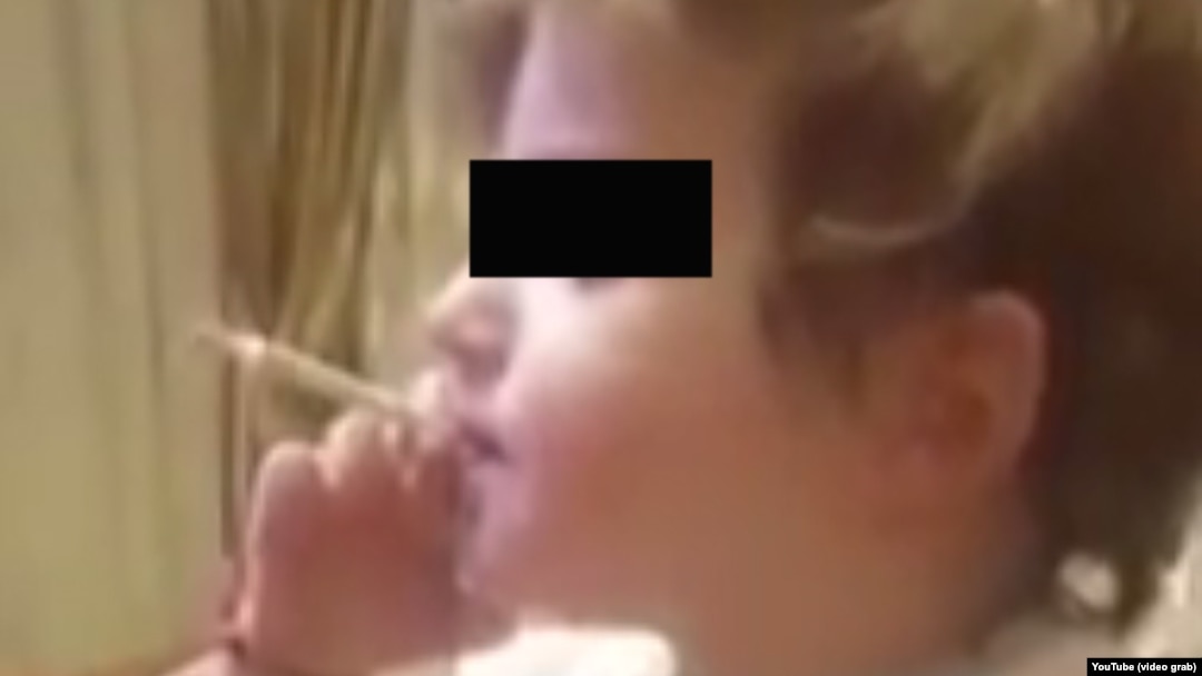 "I am a good boy," 2-year-old Timur says as he blows out another cloud of tobacco smoke.
