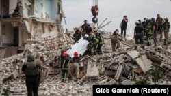 Rescuers remove a body from a residential building damaged by a Russian military strike in the town of Chasiv Yar on July 10.