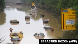 Submerged cars and other vehicles are seen on the federal highway B265 in Erftstadt, western Germany, on July 17, 2021,