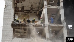 Ukrainian rescuers work at a military educational facility that was hit by missiles in Poltava, in eastern Ukraine on September 3.