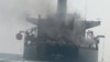 Smoke billows from a Panama-flagged oil tanker in the Strait of Hormuz in mid-September. Iran said the vessel hit sea mines, while the US military said it was hit by an Iranian missile.