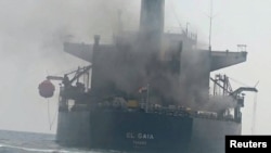 Smoke billows from a Panama-flagged oil tanker in the Strait of Hormuz in mid-September. Iran said the vessel hit sea mines, while the US military said it was hit by an Iranian missile.