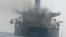 Smoke billows from a Panama-flagged oil tanker in the Strait of Hormuz in mid-September. Iran said the vessel hit sea mines, while the US military said it was hit by an Iranian missile.