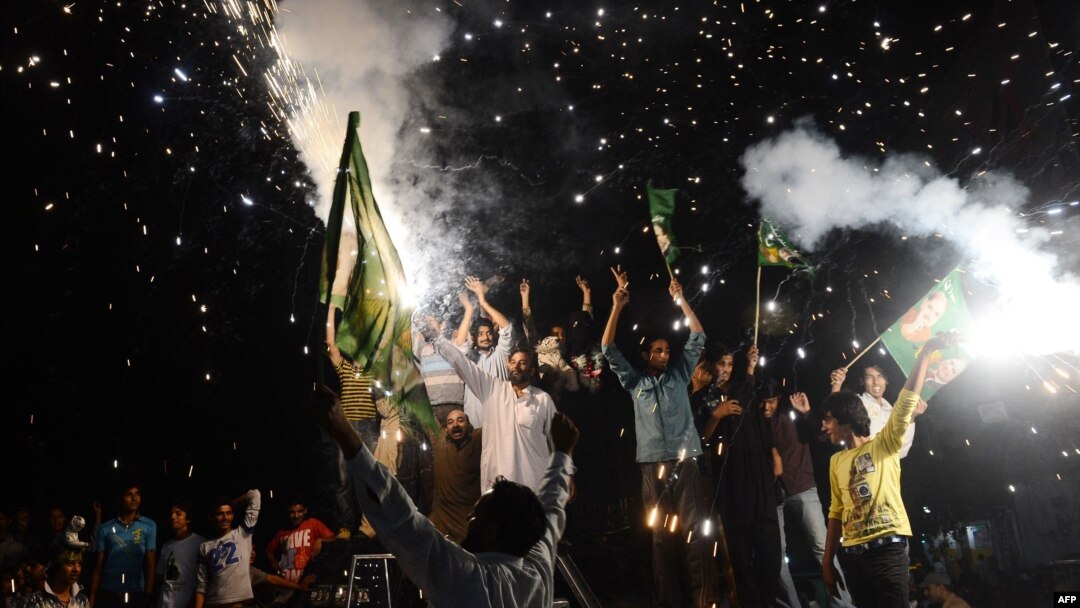 Supporters of Nawaz Sharif celebrate with fireworks in Lahore on May 12.