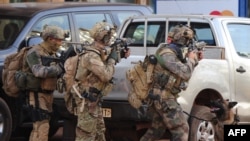Сотрудники службы безопасности заняли позицию у отеля, атакованного террористами. Уагадугу, 16 января 2016 года. 