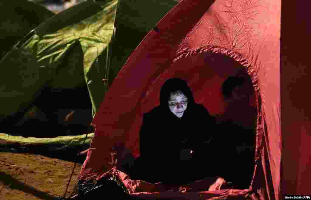 A Muslim pilgrim checks her mobile phone as she rests in a tent near Mount Arafat, also known as Jabal al-Rahma (Mount of Mercy), southeast of the Saudi holy city of Mecca on August 31. (AFP/Karim Sahib)