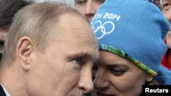 Russian President Vladimir Putin with Olympic Village Mayor Yelena Isinbayeva in Sochi on February 5, 2014.