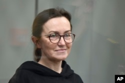 RFE/RL journalist Alsu Kurmasheva stands in a glass cage in a courtroom in Kazan, Russia, on February 1.