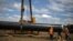 Workers move a section of pipe at a construction site on the extension of Russia's TurkStream gas pipeline in Letnitsa, Bulgaria, in June 2020. 