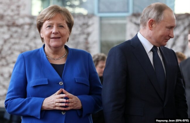 Ангела Меркель и Владимир Путин на международной конференции по Ливии в Берлине. Январь 2020 года