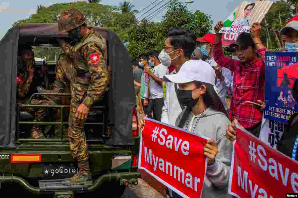 BURMA -- MYANMAR --&nbsp;​A soldier steps out of a military vehicle outside Myanmar&#39;s Central Bank during a protest against the military coup, in Yangon, Myanmar, February 15, 2021.