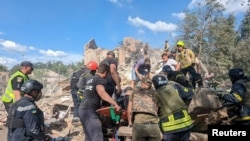 Rescuers work at a site of a deadly Russian missile strike in Kryviy Rih on June 12.