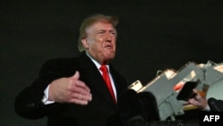 US President Donald Trump speaks with reporters upon his arrival to Joint Base Andrews, Maryland on October 10.