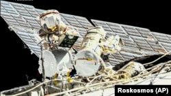 Russian cosmonauts Oleg Novitsky (left) and Pyotr Dubrov perform their first spacewalk on June 2.