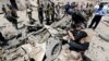 Iraqi security forces inspect the site of a car-bomb attack in a Baghdad neighborhood on August 28.