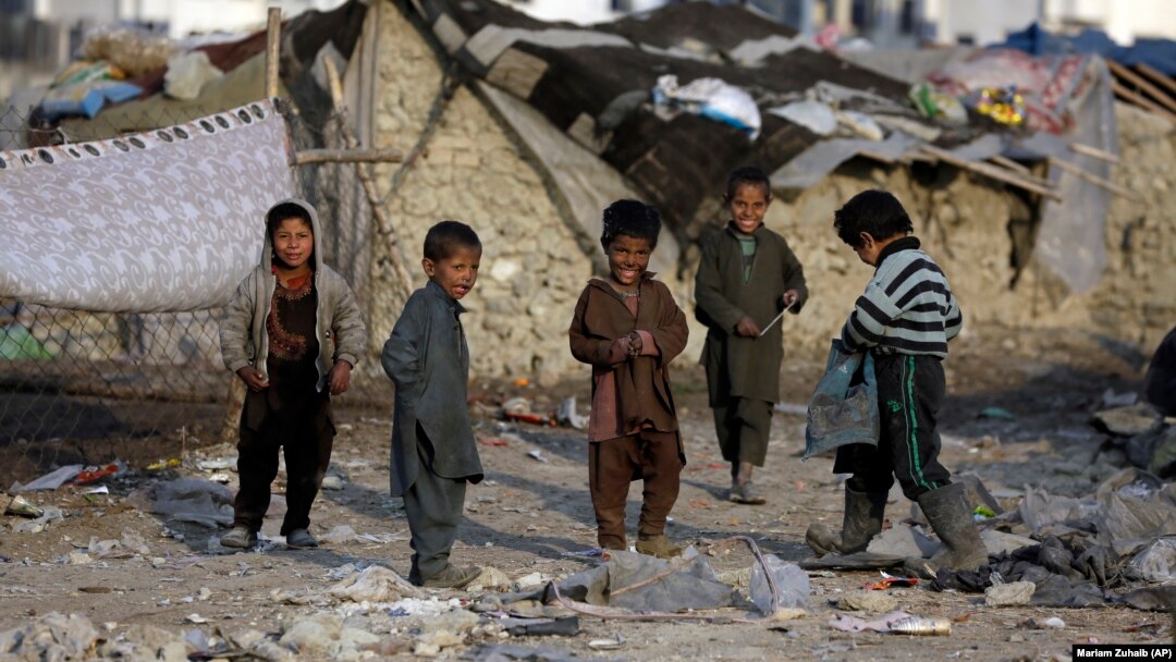 Internally displaced boys play outside their temporary home in Kabul. (file photo)