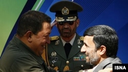 Deadly embrace? Venezuela's Hugo Chavez and Iran's Mahmud Ahmadinejad at a welcoming ceremony in Tehran in April 2009.