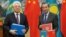 Kazakh Foreign Minister Beibut Atamkulov (left) and Chinese Foreign Minister Wang Yi attend a signing ceremony at the Diaoyutai State Guesthouse in Beijing on March 28.