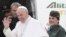 ope Francis waves to reporters before embarking on an historic visit to Egypt.