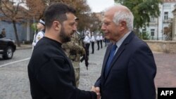 Ukrainian President Volodymyr Zelenskiy (left) shakes hands with EU foreign policy chief Josep Borrell in Kyiv.