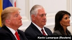 U.S. President Donald Trump (L), Secretary of State Rex Tillerson (C) and Ambassador to the U.N. Nikki Haley (R) attend a working dinner with Latin American leaders in New York, U.S., September 18, 2017