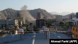 Smoke rises from a building during an ongoing attack between Afghan security force and a suicide bomber in the Shahr-e-Naw area in Kabul on May 9.