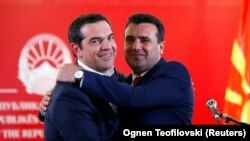 Greek Prime Minister Alexis Tsipras (left) and North Macedonian Prime Minister Zoran Zaev hug as they attend a news conference in Skopje on April 2. 