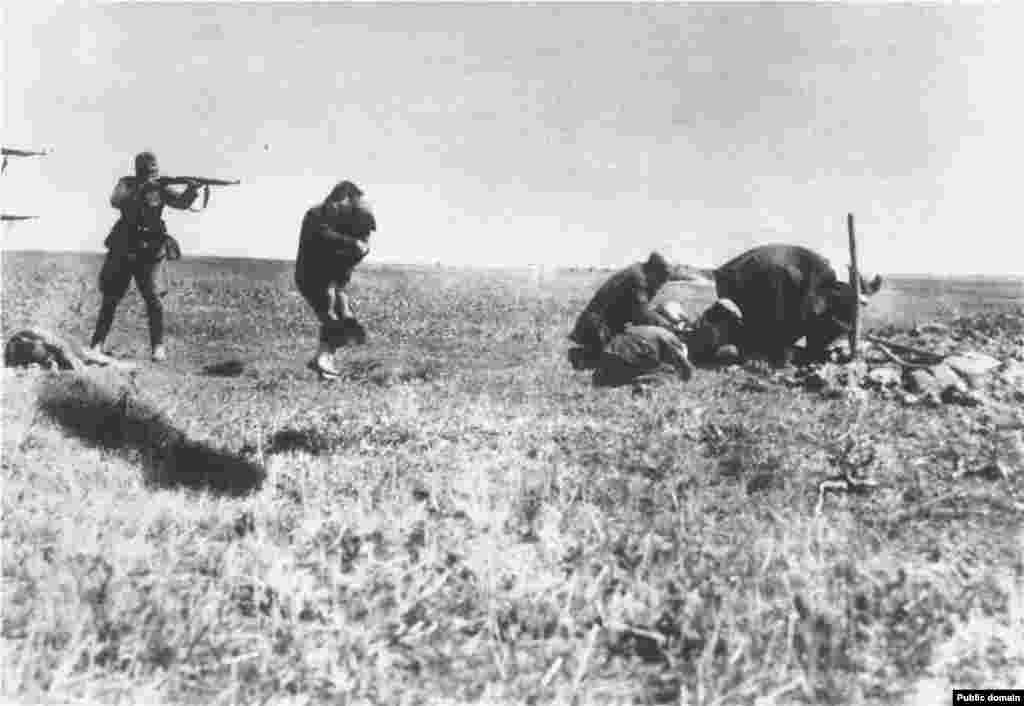 A mother attempts to shield her child from Nazi bullets moments before being killed in a field near Ivangorod, Ukraine. At left is the body of another woman, and at right a group of people apparently digging a grave. &nbsp; Nazi death squads -- in some cases supported by local populations -- executed millions of people, especially targeting Jews and &quot;Asiatics&quot; in the years following the Barbarossa invasion.