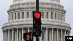 A stoplight is seen in front of the dome of the US Capitol as a government shut down looms in Washington, DC, on September 28, 2023.