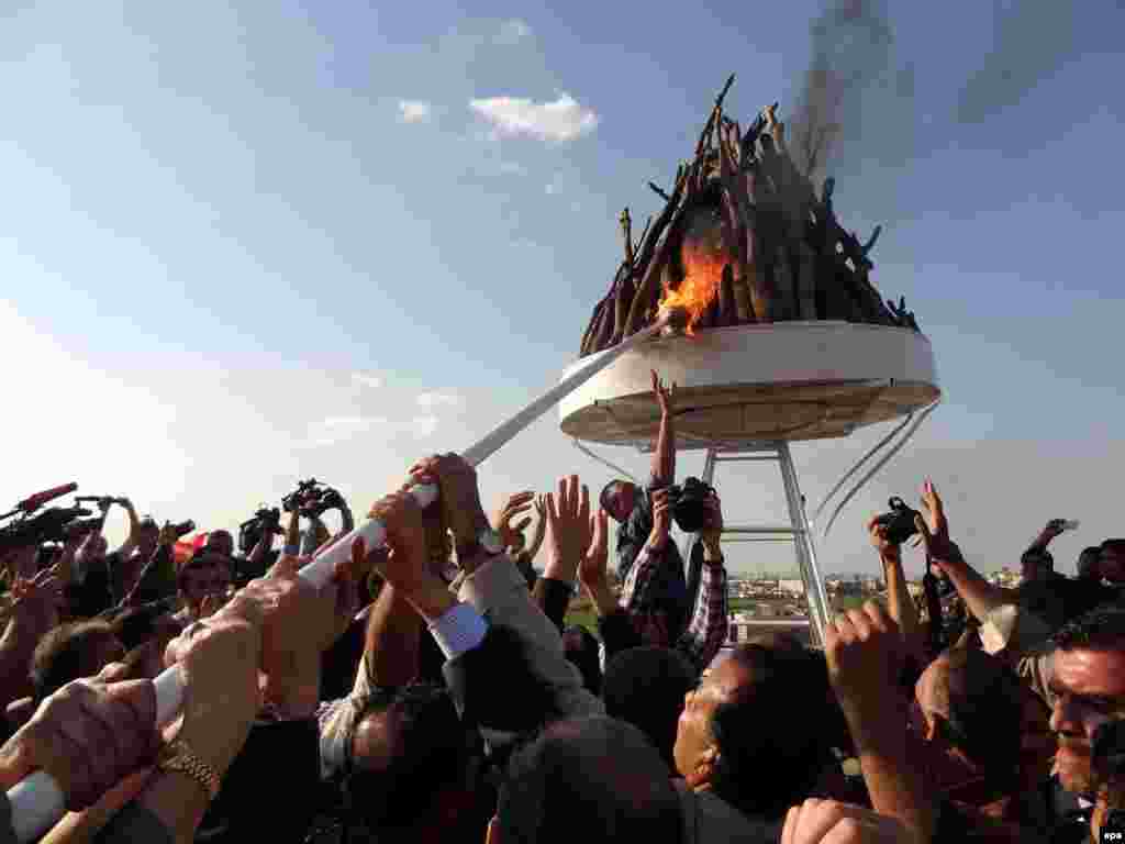 Iraqi Kurdish men gather around a bonfire as they celebrate Norouz in the northern Iraqi city of Kirkuk.