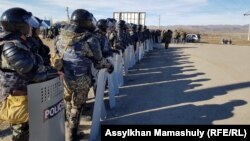 Riot police deployed to the village of Masanchi on February 8.