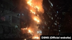 A nine-story residential building ablaze in Kyiv after a Russian air strike on October 13, 2026.