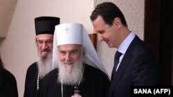 Predsjednik Sirije Bašar al Asad (D) i patrijarh Srpske pravoslavne crkve Irinej (L) tokom susreta u Damasku 3. juna 2019. 