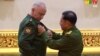 Russia's Deputy Defense Minister Aleksandr Fomin (left) receives a medal from Burma's armed forces chief, Senior General Min Aung Hlaing, on March 26.