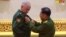 Russia's Deputy Defense Minister Aleksandr Fomin (left) receives a medal from Burma's armed forces chief, Senior General Min Aung Hlaing, on March 26.