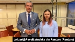 Belarusian opposition politician Paval Latushka greets sprinter Krystsina Tsimanouskaya upon her arrival in Warsaw on August 4. 