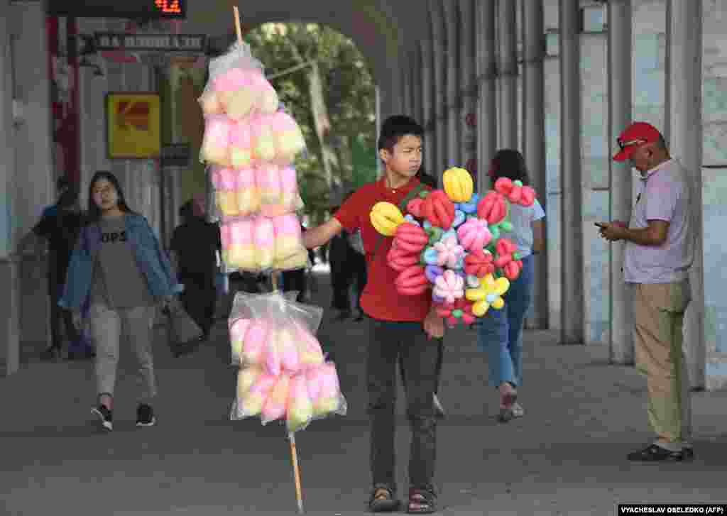 A boy sells sweets and balloons in Ala-Too Square in Bishkek.