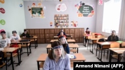 KOSOVO -- Students wearing a 3D printed face shield and gloves attend a class at the "Faik Konica" primary school in Pristina , June 9, 2020