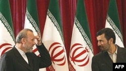 Iranian Foreign Minister Manuchehr Mottaki (left) and President Mahmud Ahmadinejad waiting to greet foreign ambassadors in Tehran in 2008.