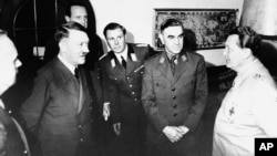 Adolf Hitler (2nd left) and Ante Pavelic (2nd right) listen to Reichsmarshal Hermann Goering (right) at the Berghof Obersalzburg, near Berchtesgaden, Germany, in June 1941.