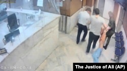 Guards drag an emaciated prisoner at Evin prison in Tehran.