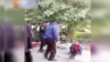 Image capture from Iran purportedly showing a street vendor being beaten by municipality agents