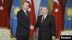 FILE: Kazakh President Nursultan Nazarbaev (R) with his Turkish counterpart Tayyip Erdogan.