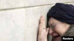 A woman weeps at the Lubyanka metro station in Moscow, the site of the deadliest attack.