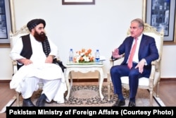 Taliban Foreign Minister Amir Khan Muttaqi meets with Pakistan’s Foreign Minister Shah Mehmood Qureshi in Islamabad in December.