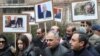 Armenia - Opposition supporters hold pictures of former Vanadzor Mayor Mamikon Aslanian and other arrested opposition members during a demonstration in Yerevan, December 17, 2021.