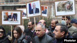 Armenia - Opposition supporters hold pictures of former Vanadzor Mayor Mamikon Aslanian and other arrested opposition members during a demonstration in Yerevan, December 17, 2021.