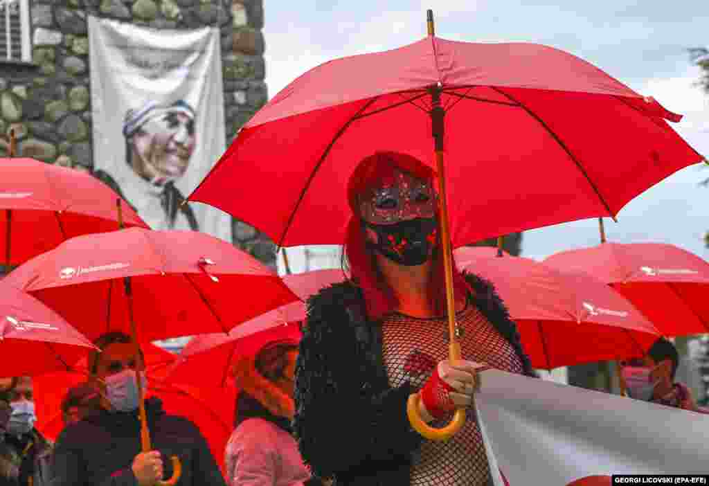 Macedonian sex workers carrying red umbrellas walk in front of the memorial house of Mother Teresa during a rally to mark the International Day to End Violence Against Sex Workers in Skopje, North Macedonia. Sex workers face a much greater risk of being exposed to sexual violence on the job.