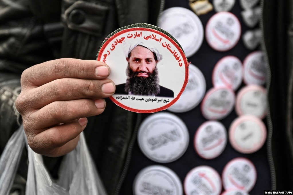 A man holds stickers depicting Taliban supreme leader Mullah Haibatullah Akhundzada at a market in Kabul. (file photo)