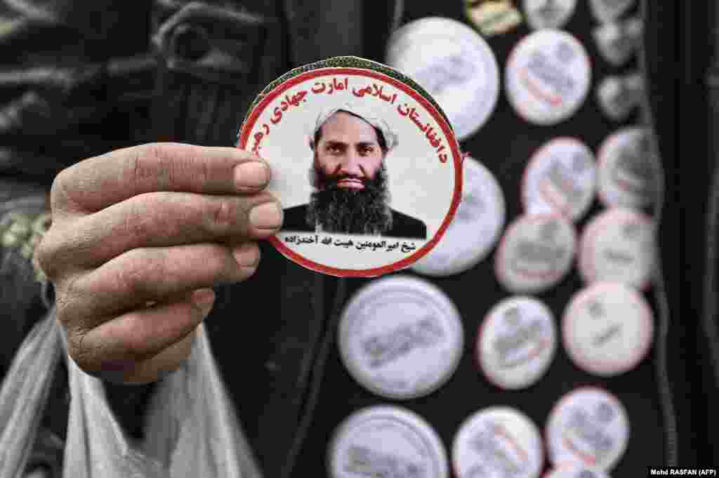 A man sells stickers picturing the Taliban&#39;s supreme leader, Haibatullah Akhundzada, at a market in Kabul.